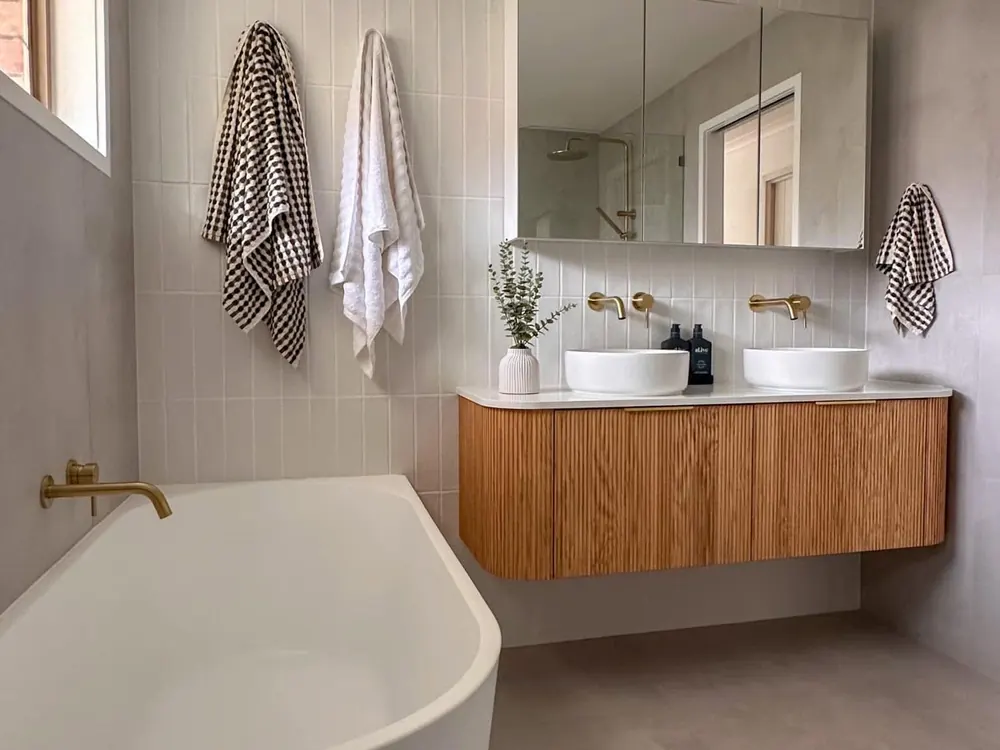 Renovated Gold Coast bathroom with freestanding bath, timber vanity and brass tapware plumbed by LB Plumbing Group
