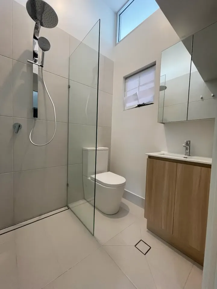 Full bathroom redesign from demolition and plumbing rough-in through to the finished walk-in shower and timber vanity