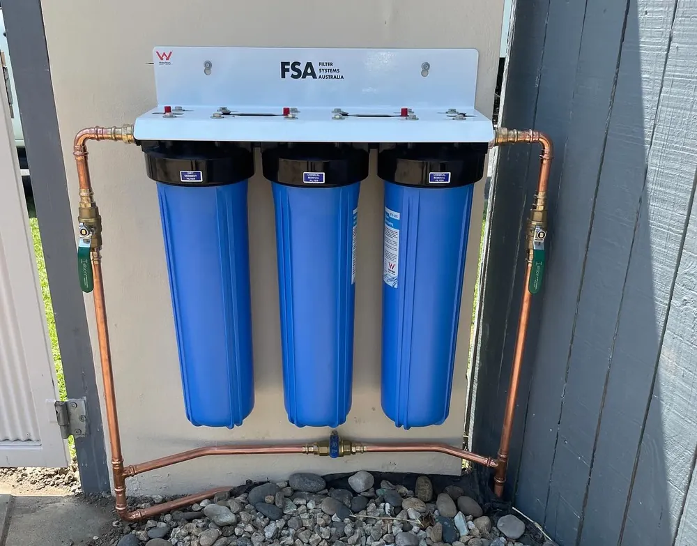 Triple-stage whole-of-house water filtration system installed with copper pipework and isolation valves